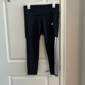 Never worn Adidas leggings with white strips on side.